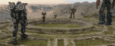 Group Of Robots Standing In A Circle In A Field GIF