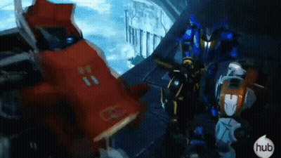 Group Of Robots Standing Together In A Room GIF