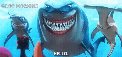 Group Of Sharks Swimming One Smiling Says Hello GIF