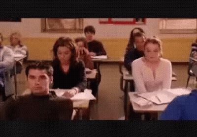 Group Of Students Sitting At Desks In Classroom GIF