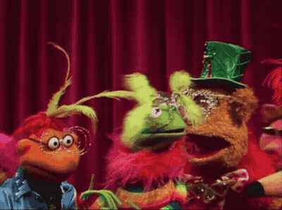 Group Of Stuffed Animals On Stage With Red Curtain GIF