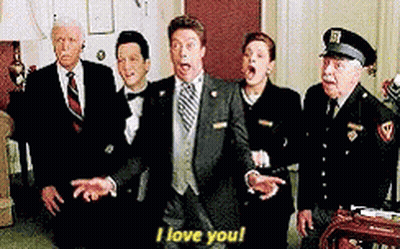 Group Of Suited People Standing Around Man In Suit GIF