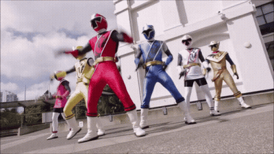 Group Of Superheroes Standing In Front Of Building GIF