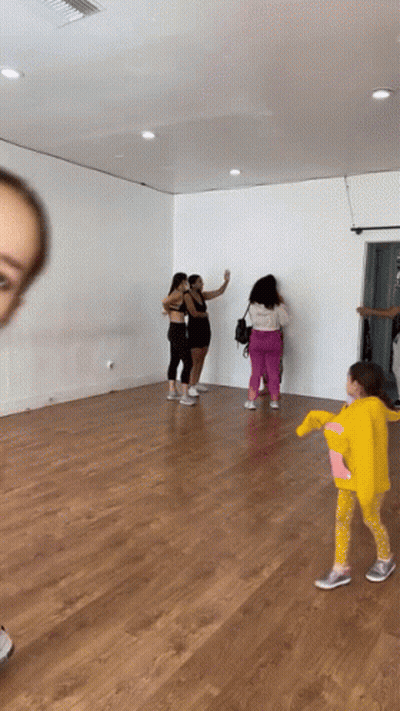 Group Of Women And Little Girl In Yellow Hoodie In Dance Studio GIF