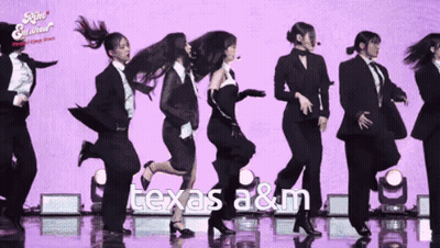 Group Of Women Dancing Before Purple Texas A&M Background GIF