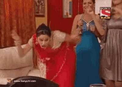 Group Of Women Dancing, One In Red Saree GIF