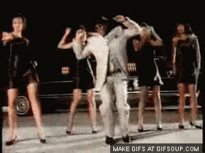 Group Of Women Dancing With Man In White Suit GIF