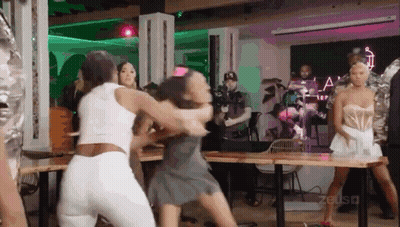 Group Of Women Fighting While Man Stands Behind GIF