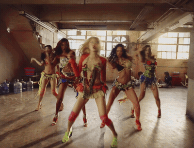 Group of Women in Colorful Outfits Dancing