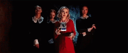 Group Of Women In Dark Room One Holding Camera GIF