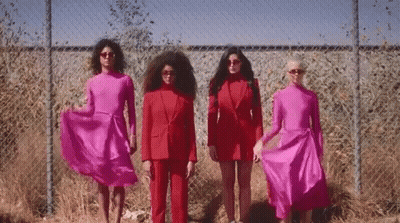 Group Of Women In Red By Chain Link Fence GIF