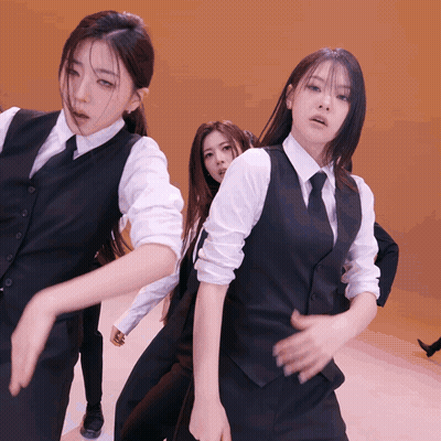 Group Of Women In Suits And Ties Dancing On Stage GIF