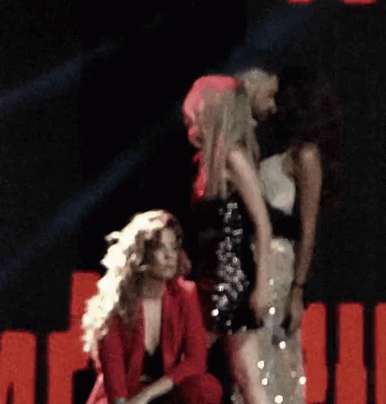 Group Of Women On Stage In Dark Room GIF
