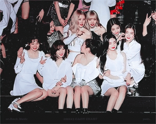 Group Of Women Posing With Er Rock Music In Corner GIF