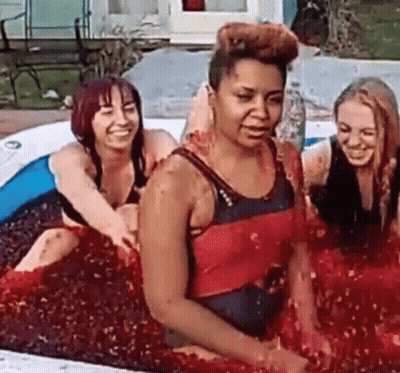Group Of Women Sitting In Red Liquid Pool GIF