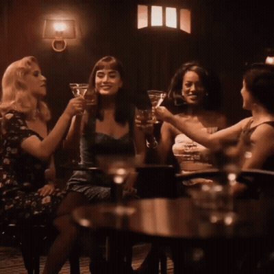 Group Of Women Toasting At Table GIF