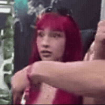 Group Of Wrestlers Standing Hands Behind Heads GIF