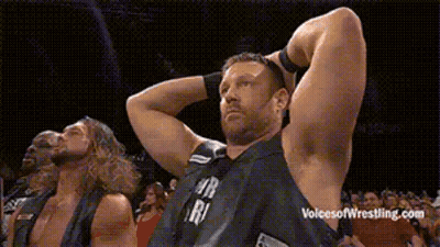 Group Of Wrestlers Standing With Hands Behind Head GIF