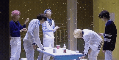 Group Of Young Men Around Snow-Covered Table GIF
