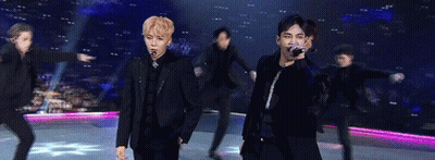 Group Of Young Men Holding Microphones On Stage GIF
