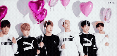 Group Of Young Men Holding Pink Balloons GIF