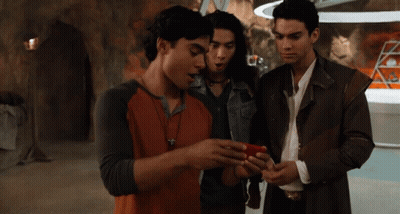 Group Of Young Men Looking At Cell Phone GIF