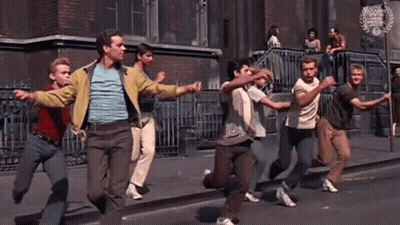 Group Of Young Men Running Down Street Holding Hands GIF