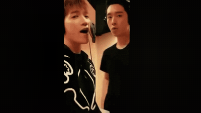 Group Of Young Men Singing Into Microphones GIF