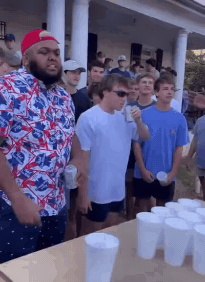 Group Of Young Men Standing Around Table With Cups GIF
