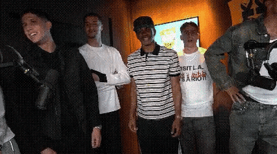 Group Of Young Men Standing In Front Of Microphone GIF