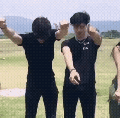 Group Of Young Men Standing In Grassy Field GIF
