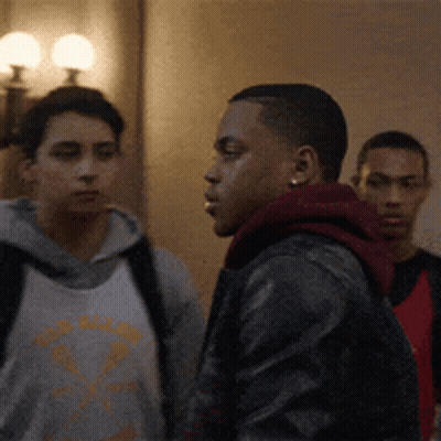 Group Of Young Men Standing In Hallway GIF