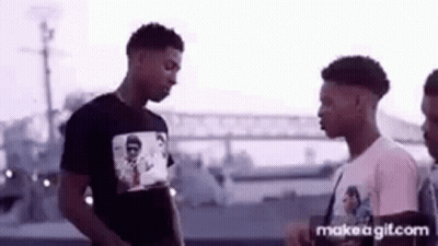 Group Of Young Men Standing On Street GIF
