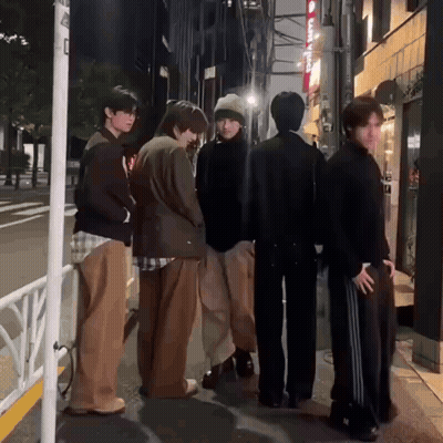Group Of Young Men Standing On Street GIF