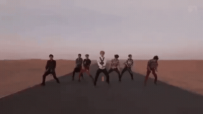Group On Desert Road Arms Raised GIF