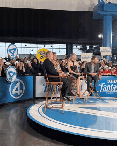 Group On Stage With Fantastic 4 Sign GIF