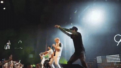 Group On Stage With Sign Saying G GIF