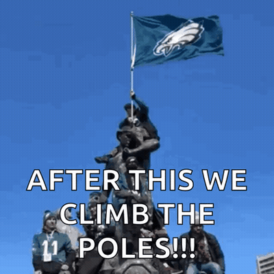 Group On Statue Holding Flag Saying After This We Climb The Poles GIF