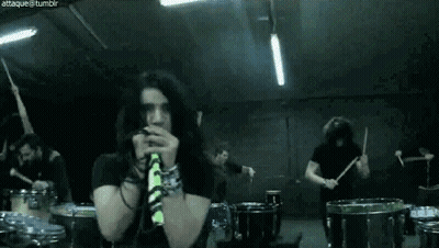 Group Playing Drums In Dark Room With Man On Mic GIF