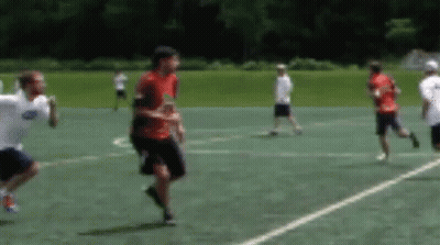 Group Playing Frisbee On Field GIF
