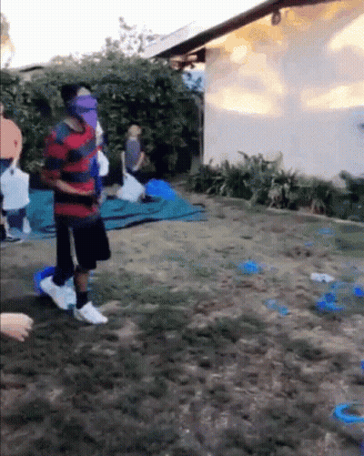 Group Playing Game In Backyard With Blindfolded Man GIF