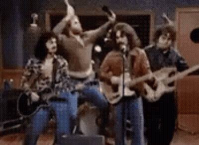 Group Playing Guitars And Singing Into Microphones GIF