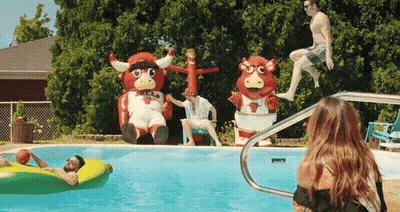 Group Playing In Pool With Bull Mascot GIF