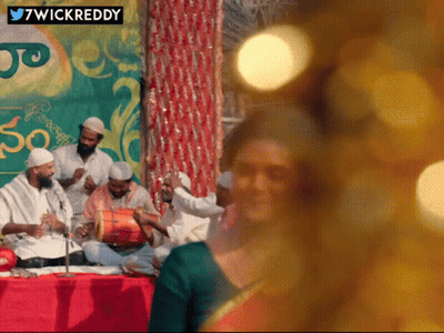 Group Playing Instruments In Front Of 7Wickreddy Sign GIF