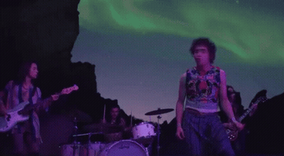 Group Playing Instruments On Stage In Front Of Mountain GIF