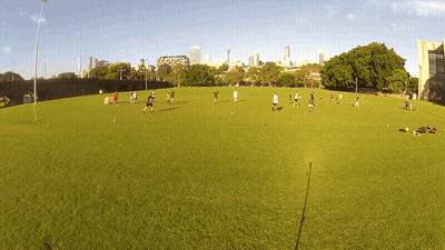 Group Playing Soccer On Field GIF