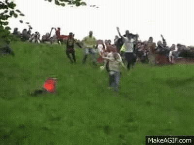 Group Playing Soccer On Grassy Hill GIF