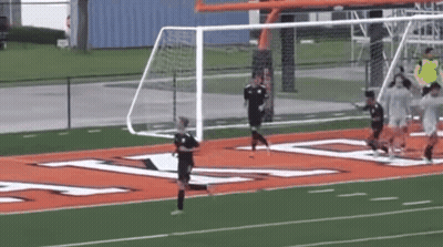 Group Playing Soccer With Sign Saying A GIF