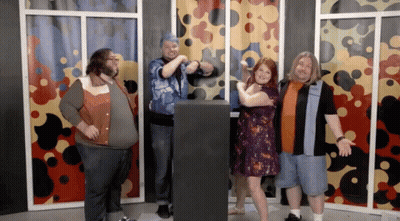 Group Posing In Front Of Colorful Curtain GIF