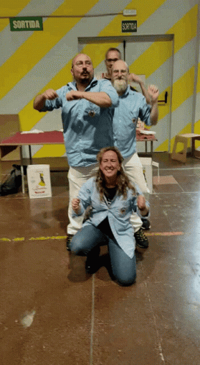 Group Posing In Front Of Green Sortida Exit Sign GIF